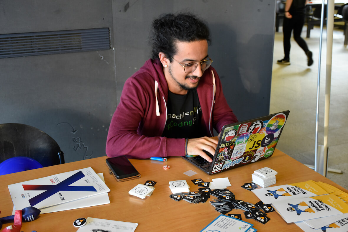 A white hat hacker on his Linux laptop during Linux Day