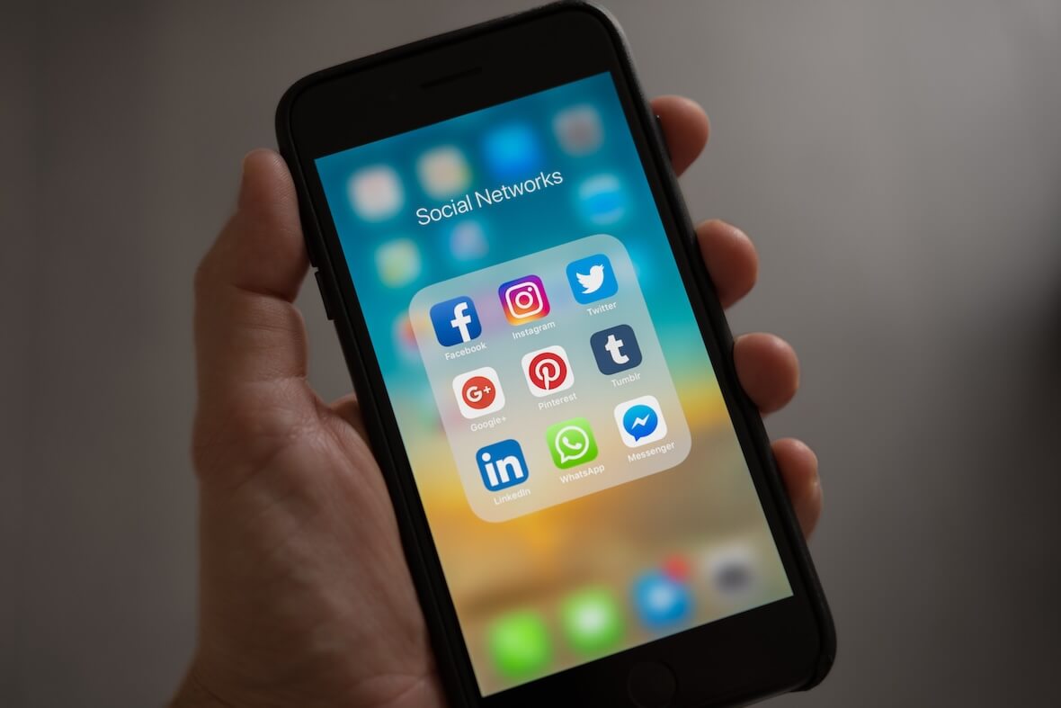 An image of an iPhone with social media apps.