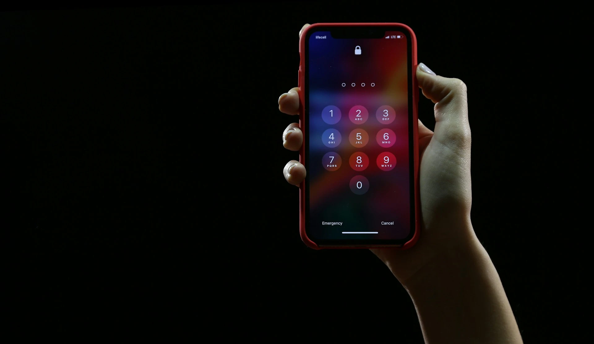 A photo showing an iPhone password lock screen with a dark background.