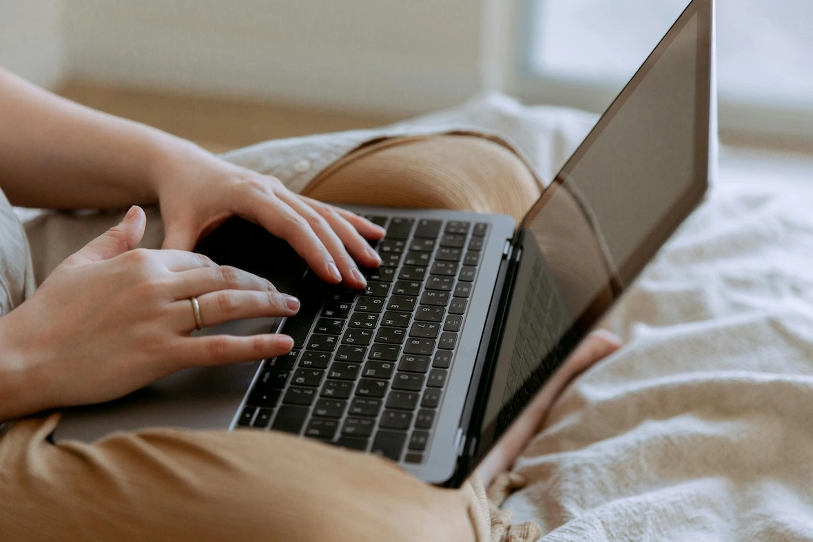 Woman typing on keyboard on Mac