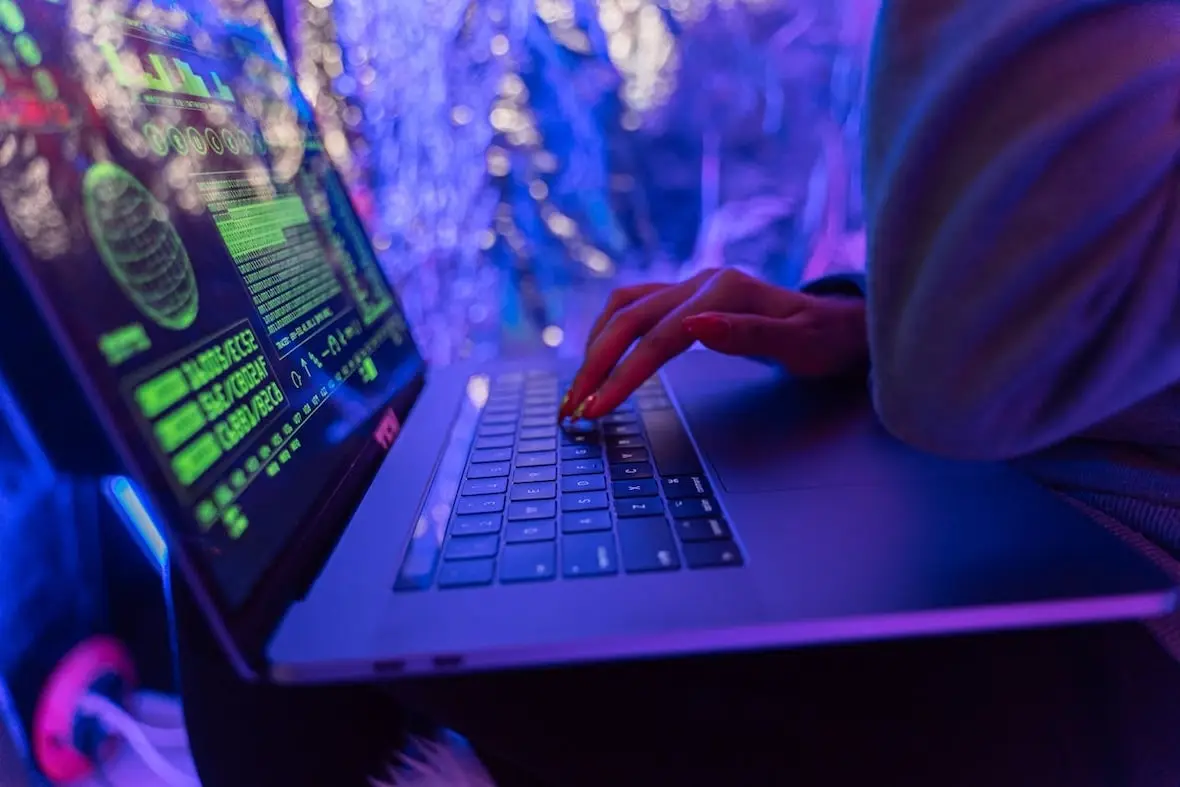 A photo of a person using a laptop.