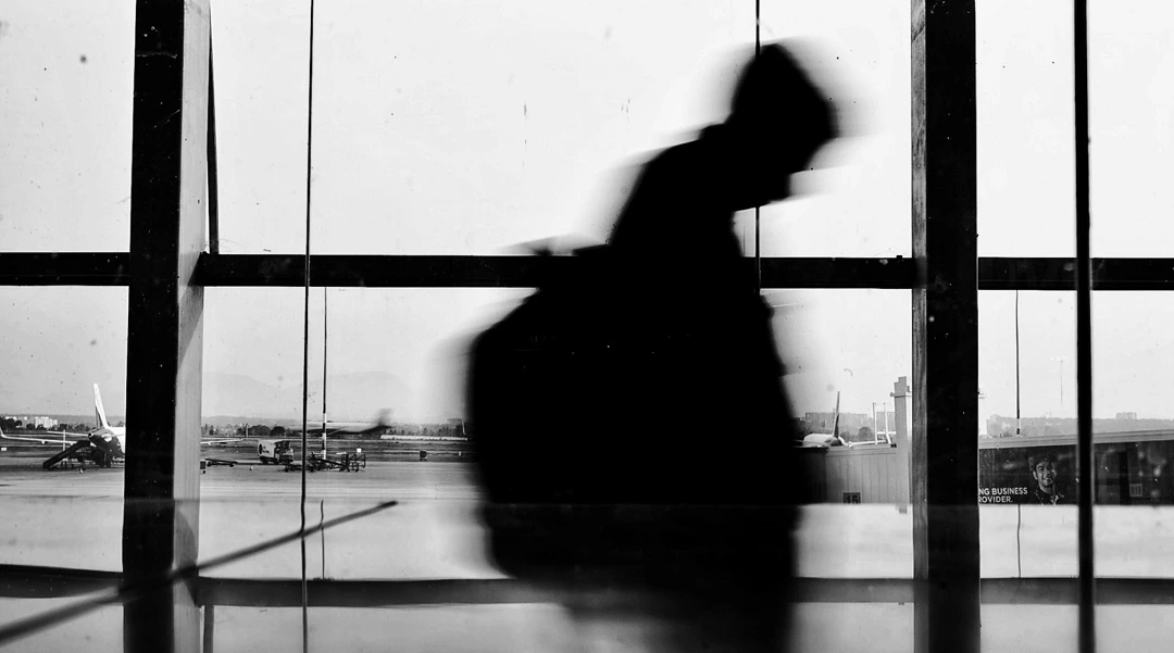 An image of a traveler walking in an airport.